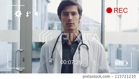 Portrait of smiling young male doctor displayed on a digital camera in 4k record mode. Portrait of smiling young male doctor displayed on a digital camera in 4k record mode. 115721210