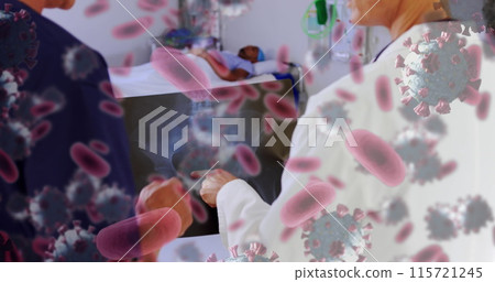 Doctor and nurse discuss Covid-19 amidst floating virus cells in a digital health concept. 115721245