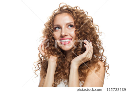 Smiling young adult woman with fresh skin and wavy long healthy hairstyle isolated Smiling young adult woman with fresh skin and wavy long healthy hairstyle isolated 115722589