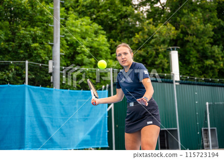 Professional female tennis player serving the tennis ball during playing on outside court 115723194