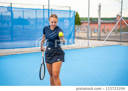 Professional female tennis player serving the tennis ball during playing on outside court Professional female tennis player serving the tennis ball during playing on outside court 115723204