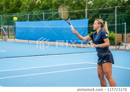 Professional female tennis player playing the tennis on outside court 115723278