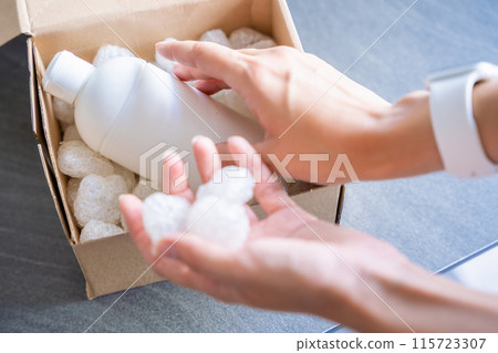 Eco packaging of parcels and white biodegradable filler. Box is filled with a filler safety for environment. Delivery of goods, parcels, delivery service, nature protection and recycling concept 115723307