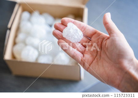 Eco packaging of parcels and white biodegradable filler. Box is filled with a filler safety for environment. Delivery of goods, parcels, delivery service, nature protection and recycling concept Eco packaging of parcels and white biodegradable filler. Box is filled with a filler safety for environment. Delivery of goods, parcels, delivery service, nature protection and recycling concept 115723311