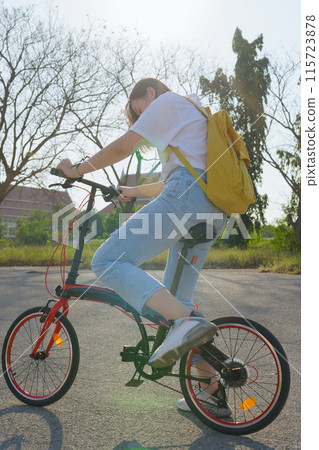 spring is comming concept with happy and cheerful feeling of asian woman riding bicycle spring is comming concept with happy and cheerful feeling of asian woman riding bicycle 115723878
