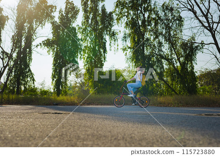 spring is comming concept with happy and cheerful feeling of asian woman riding bicycle 115723880