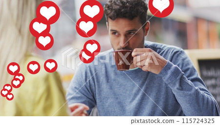Image of heart icons floating over happy caucasian couple talking and drinking coffee 115724325