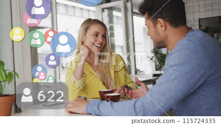 Image of social media icons floating over happy caucasian couple talking and drinking coffee Image of social media icons floating over happy caucasian couple talking and drinking coffee 115724335