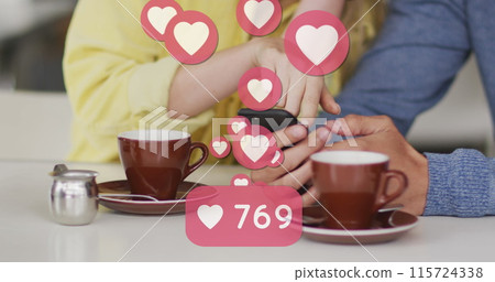 Image of heart icons floating over caucasian couple using smartphone and drinking coffee 115724338