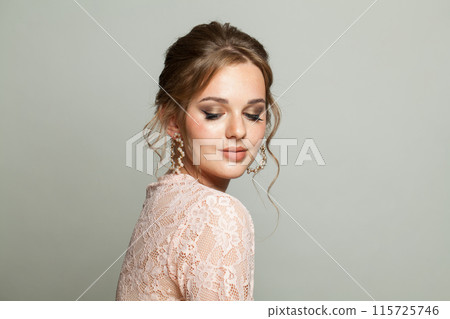 Elegant adorable woman wearing pink lace blouse. Model with make-up and updo hair, beautiful hairdo Elegant adorable woman wearing pink lace blouse. Model with make-up and updo hair, beautiful hairdo 115725746