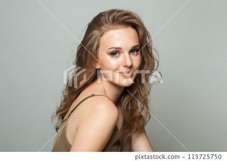 Smiling woman face. Woman with makeup, curly hairstyle and fresh skin on white background 115725750