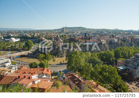 Landscape of old town Tbilisi with red roof on the background of blue sky 115725785