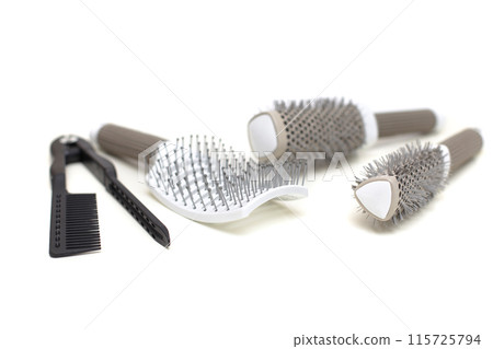 White hair brushes or combs on white background. Coiffure and beauty salon tool. White hair brushes or combs on white background. Coiffure and beauty salon tool. 115725794
