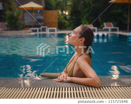 Vacation lifestyle scene of young woman sitting in swimming pool in morning time. Weekend and holiday lifestyle concept. 115725846