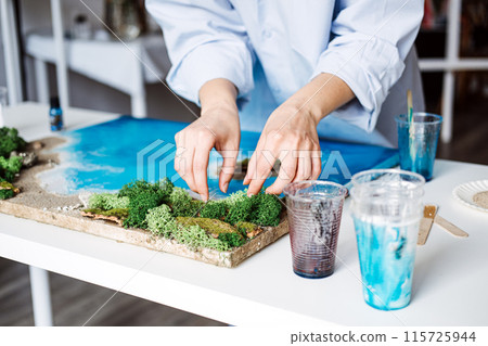 Artist Applying Final Touches to a 3D Epoxy Resin Coastal Artwork 115725944