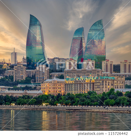 Night view of the iconic illuminated Flame Towers in Baku, Azerbaijan, reflected in the calm waters of the Caspian Sea Night view of the iconic illuminated Flame Towers in Baku, Azerbaijan, reflected in the calm waters of the Caspian Sea 115726442