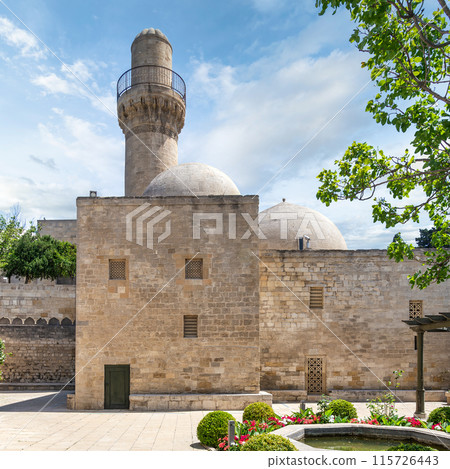Shah Mosque minaret stands tall in Baku, Azerbaijan, attached to the Palace of the Shirvanshahs 115726443