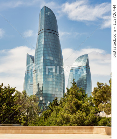View from Martyrs Lane of the iconic Flame Towers in Baku, Azerbaijan stand tall against a blue sky, resembling flames View from Martyrs Lane of the iconic Flame Towers in Baku, Azerbaijan stand tall against a blue sky, resembling flames 115726444
