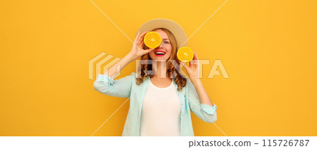 Summer portrait of happy joyful young woman with slices of orange fruit, cheerful girl smiles in hat Summer portrait of happy joyful young woman with slices of orange fruit, cheerful girl smiles in hat 115726787