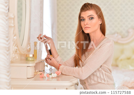 Portrait of beautiful girl doing makeup at home Portrait of beautiful girl doing makeup at home 115727588