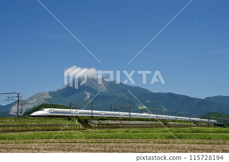 A Shinkansen train running under a blue sky with Mt. Ibuki in the background in summer A Shinkansen train running under a blue sky with Mt. Ibuki in the background in summer 115728194