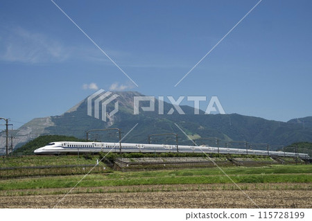 A Shinkansen train running under a blue sky with Mt. Ibuki in the background in summer A Shinkansen train running under a blue sky with Mt. Ibuki in the background in summer 115728199