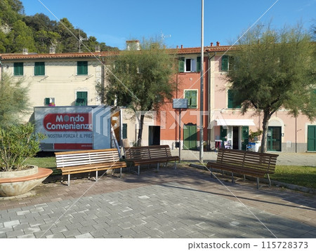 Riva Trigoso, Sestri Levante, Liguria, Italy, September 21, 2023: view of pedestrian promenade in Riva Trigoso village with small square, bench and trees at sunny day 115728373