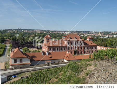 Troja Castle panoramic cityscape view with Prague castle behind and vineyards in front. Baroque palace building in the Troja district of Prague from 1685, seen from botanic garden 115728454