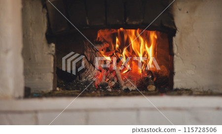 Burning fire in a Russian stove in the village. Burning fire in a Russian stove in the village. 115728506