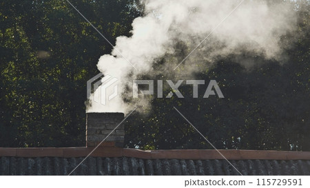 White smoke from the chimney of the village house. White smoke from the chimney of the village house. 115729591