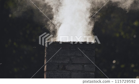 White smoke from the chimney of the village house. White smoke from the chimney of the village house. 115729592