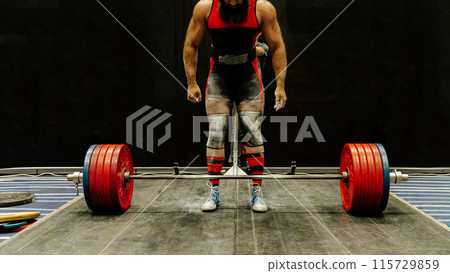 indian powerlifter stand in front barbell with record weight at deadlift competition 115729859