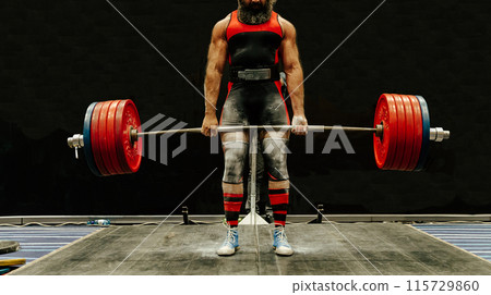 athlete lift heavy weight of barbell at deadlift competition 115729860
