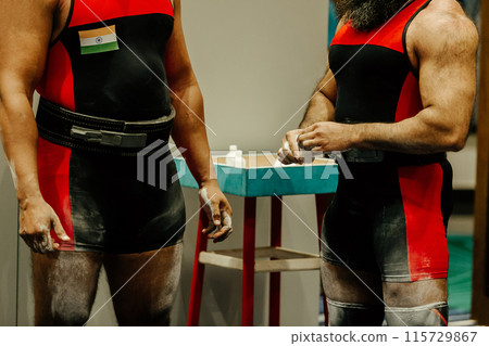 two iranian powerlifter athletes in talcum powder at powerlifting competition 115729867