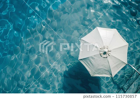 Aerial view of a swimming pool with a white umbrella by the side, depicting a summer vacation concept. Minimalistic Aerial view of a swimming pool with a white umbrella by the side, depicting a summer vacation concept. Minimalistic 115730857