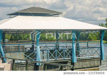 wooden the roof pier dock on the lake . High quality photo 115730858