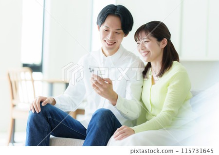 Young couple looking at a smartphone Young couple looking at a smartphone 115731645