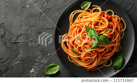Dark plate with Italian spaghetti on a dark background. 115731667