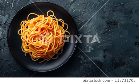 Dark plate with Italian spaghetti on a dark background. 115731703
