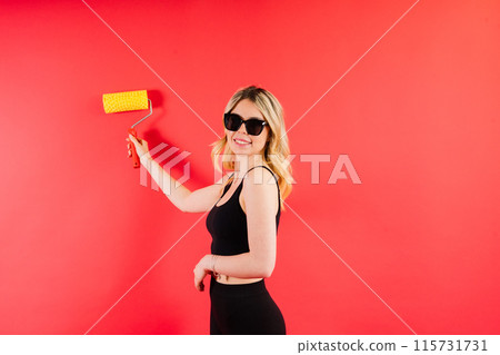 Young minded employee laborer handyman woman choosing roller brush paint Young minded employee laborer handyman woman choosing roller brush paint 115731731