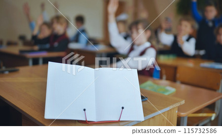Notebook on a stand in the classroom during a lesson. Notebook on a stand in the classroom during a lesson. 115732586