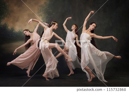 Beautiful ballerinas in delicate dresses capture a moment of ethereal grace against vintage studio background. 115732868