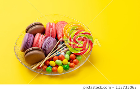Various colorful candies, lollipops, and macaroons Various colorful candies, lollipops, and macaroons 115733062