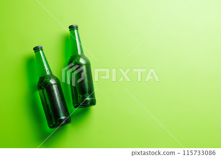 Beer bottles on green background 115733086