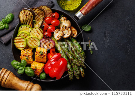 Assorted grilled vegetables on a frying pan, showcasing a colorful and healthy meal 115733111
