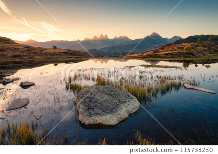 Landscape of sunrise shines over Lac Guichard with Arves massif and lake reflection in autumn at French Alps, France 115733230