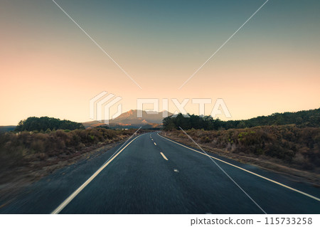 Road trip with golden sunrise over volcanic mountain on wilderness Road trip with golden sunrise over volcanic mountain on wilderness 115733258