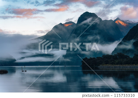 Milford Sound with Mitre peak and foggy on the lake at Fjordland national park, New Zealand 115733310