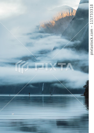 Milford Sound with waterfall in foggy on the lake at Fjordland national park, New Zealand Milford Sound with waterfall in foggy on the lake at Fjordland national park, New Zealand 115733318