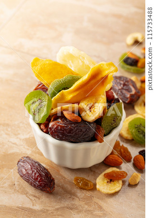 Dried tropical fruits with various nuts and raisins. Dried tropical fruits with various nuts and raisins. 115733488